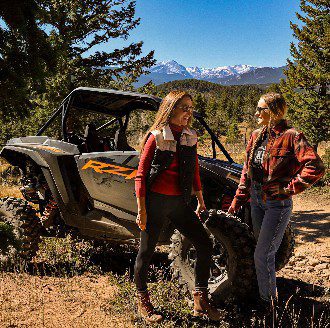 Mother Daughter UTV Ride Mother and daughter posing next to Polaris atv rental in estes park colorado