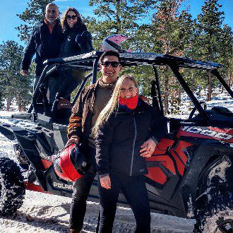 Backbone Adventures | Winter UTV rental ride Friends UTV rental ride in the winter posing next to razor